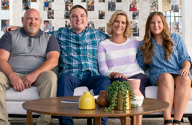 Family sitting on a couch, talking about the rewards of adopting teens and becoming a family.