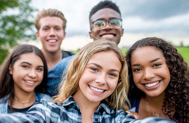 Diverse group of teens taking a selfie.
