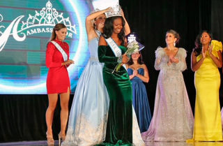 Jamerika on stage being crowned USA Ambassador Ms. 2021