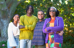 The Jones family smiles outside, with trees in the background