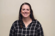 Outstanding caseworker Kelley Cooper is a white woman with brown hair, and she's pictured in this professional headshot.