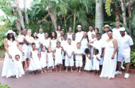 Keeshann Jones and family posing for photo in white clothing.
